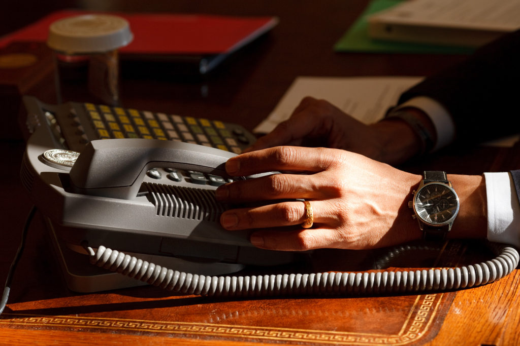 President Barack Obama places a phone call at his desk in the Oval Office. 1/23/09 Official White House Photo by Pete Souza